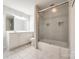 Well-lit bathroom features tiled floors, vanity with sink, and a glass-enclosed shower at 3319 Mill Pond Rd, Charlotte, NC 28226