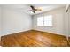Cozy bedroom featuring hardwood flooring, a ceiling fan and a built-in closet with sliding doors at 3319 Mill Pond Rd, Charlotte, NC 28226