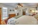 Main bedroom with hardwood floors, ceiling fan and ensuite bathroom at 3319 Mill Pond Rd, Charlotte, NC 28226