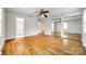Generous bedroom with hardwood floors, ceiling fan, and mirrored closet, enhancing space and functionality at 3319 Mill Pond Rd, Charlotte, NC 28226