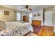 Bedroom with hardwood floors, ceiling fan, and access to bathroom at 3319 Mill Pond Rd, Charlotte, NC 28226