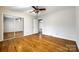 Clean bedroom offers hardwood floors, ceiling fan and a large closet with mirrored doors at 3319 Mill Pond Rd, Charlotte, NC 28226