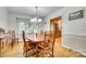 Dining room with hardwood floors, a wooden table, and access to the kitchen at 3319 Mill Pond Rd, Charlotte, NC 28226