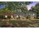 Brick ranch home with gray siding, mature landscaping, and a walkway at 3319 Mill Pond Rd, Charlotte, NC 28226