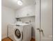 Laundry room featuring a washer, dryer, and overhead cabinets at 3319 Mill Pond Rd, Charlotte, NC 28226