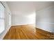 Spacious living room with gleaming hardwood floors, large windows, and neutral paint, perfect for entertaining at 3319 Mill Pond Rd, Charlotte, NC 28226
