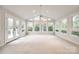 Bright sunroom featuring carpet, lots of windows, and a ceiling fan at 3319 Mill Pond Rd, Charlotte, NC 28226