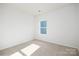 Simple bedroom with carpet, window, and neutral walls at 3711 Cullen Meadows Dr, Davidson, NC 28036