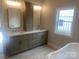 Bathroom featuring a double vanity, tub, and neutral color palette evokes a spa-like ambiance at 4033 Stadler Ne Dr # 22, Conover, NC 28613