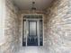 Stylish front door with decorative windows and stone surround; modern light fixture at 4033 Stadler Ne Dr # 22, Conover, NC 28613