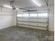 Spacious two-car garage with overhead door, concrete floors, and ample lighting at 4033 Stadler Ne Dr # 22, Conover, NC 28613