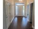 Light-filled hallway with dark wood floors, white trim and doors, and views of the home's entrance at 4033 Stadler Ne Dr # 22, Conover, NC 28613