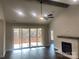 Bright living room features a stone fireplace, wood floors, beamed ceiling, and sliding glass doors to the backyard at 4033 Stadler Ne Dr # 22, Conover, NC 28613