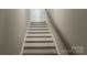 Stairwell with wood stairs, white risers, and glass railing leading to the next level at 4033 Stadler Ne Dr # 22, Conover, NC 28613