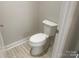Clean, minimalist powder room features a white toilet with tile flooring at 4033 Stadler Ne Dr # 22, Conover, NC 28613