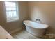 Bright bathroom showcasing a freestanding tub, providing a luxurious soaking experience at 4033 Stadler Ne Dr # 22, Conover, NC 28613