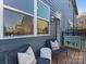 Charming deck with seating, ideal for relaxation, next to the modern home's window at 8005 Elevate Ct, Charlotte, NC 28205