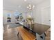 Bright dining area features modern table with bench seating and stylish chandelier at 8005 Elevate Ct, Charlotte, NC 28205