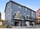 Modern townhome with balconies, gray siding, and attached garages with driveway at 8005 Elevate Ct, Charlotte, NC 28205