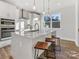 Beautiful open kitchen with white cabinets, quartz counters, stainless steel appliances, and wood-look floors at 8005 Elevate Ct, Charlotte, NC 28205