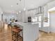 Beautiful open kitchen with white cabinets, quartz counters, stainless steel appliances, and wood-look floors at 8005 Elevate Ct, Charlotte, NC 28205