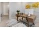 Bright home office with modern desk, stylish poufs, and a large abstract painting at 8005 Elevate Ct, Charlotte, NC 28205