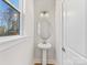 Elegant powder room featuring a pedestal sink and modern lighting fixture at 8005 Elevate Ct, Charlotte, NC 28205