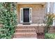 Brick front porch with black front door and landscaping at 116 Diamond Head Dr, Mooresville, NC 28117