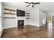 Living room with fireplace, built-in shelving and hardwood floors at 116 Diamond Head Dr, Mooresville, NC 28117