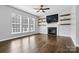 Living room with fireplace, built-in shelving and hardwood floors at 116 Diamond Head Dr, Mooresville, NC 28117