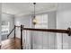 Wooden staircase with chandelier and window views at 116 Diamond Head Dr, Mooresville, NC 28117