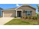 Charming one-story home featuring stone accents, a two-car garage, and a neatly landscaped front yard at 1531 Harper Landing Blvd, Stanley, NC 28164