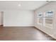 Spacious living room with hardwood style flooring and two large windows that provide plenty of natural light at 1531 Harper Landing Blvd, Stanley, NC 28164