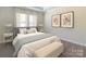 Relaxing bedroom features soft natural light from window and neutral color palette at 1531 Harper Landing Blvd, Stanley, NC 28164