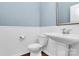 Clean bathroom with pedestal sink, toilet and white wainscoting at 19935 Wooden Tee Dr, Davidson, NC 28036