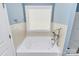 Soaking tub with tile surround and window at 19935 Wooden Tee Dr, Davidson, NC 28036