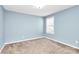 Simple bedroom with light blue walls and neutral carpet at 19935 Wooden Tee Dr, Davidson, NC 28036