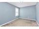 Small bedroom with light blue walls and neutral carpet at 19935 Wooden Tee Dr, Davidson, NC 28036