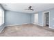 Primary bedroom with ceiling fan and walk-in closet at 19935 Wooden Tee Dr, Davidson, NC 28036