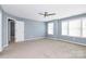 Bright bedroom with ceiling fan and neutral carpet at 19935 Wooden Tee Dr, Davidson, NC 28036