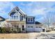 Two-story house with blue siding and two-car garage at 19935 Wooden Tee Dr, Davidson, NC 28036