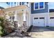 Front entry with stone pillars and two-car garage at 19935 Wooden Tee Dr, Davidson, NC 28036