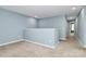 Upstairs hallway with light blue walls and carpeted floors at 19935 Wooden Tee Dr, Davidson, NC 28036