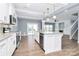 Kitchen with white cabinets, granite island, and hardwood floors at 19935 Wooden Tee Dr, Davidson, NC 28036