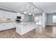 Kitchen with white cabinets, granite island, and hardwood floors at 19935 Wooden Tee Dr, Davidson, NC 28036