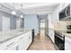 Kitchen with white cabinets, granite island, and hardwood floors at 19935 Wooden Tee Dr, Davidson, NC 28036