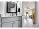 Vanity with granite countertop, black fixtures and mirror at 226 Hickory St, Locust, NC 28097