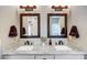 Double vanity bathroom with granite countertops and dark framed mirrors at 226 Hickory St, Locust, NC 28097