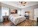 Spacious bedroom with wood floors, ceiling fan and large bed at 226 Hickory St, Locust, NC 28097