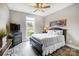 Bedroom with wood floors, dresser and large bed at 226 Hickory St, Locust, NC 28097